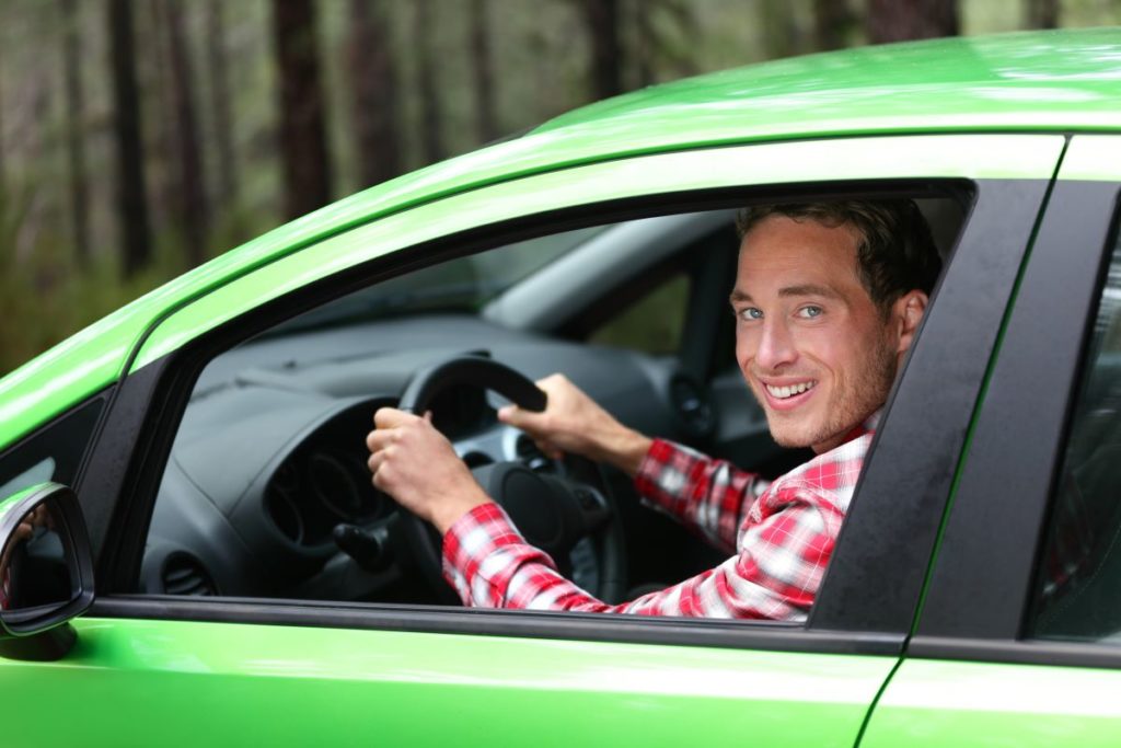man driving green car